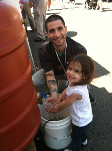 Joshua and Jasmine play in the rain barrel display!